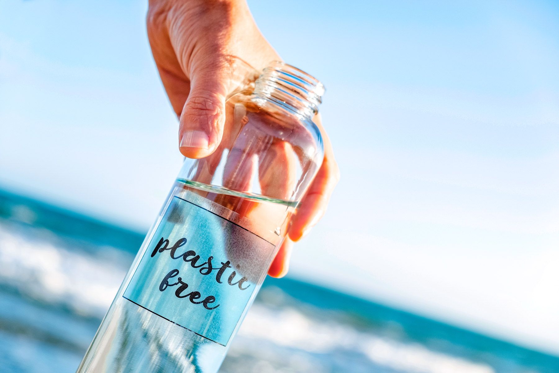 34-man-holding-glass-reusable-water-bottle