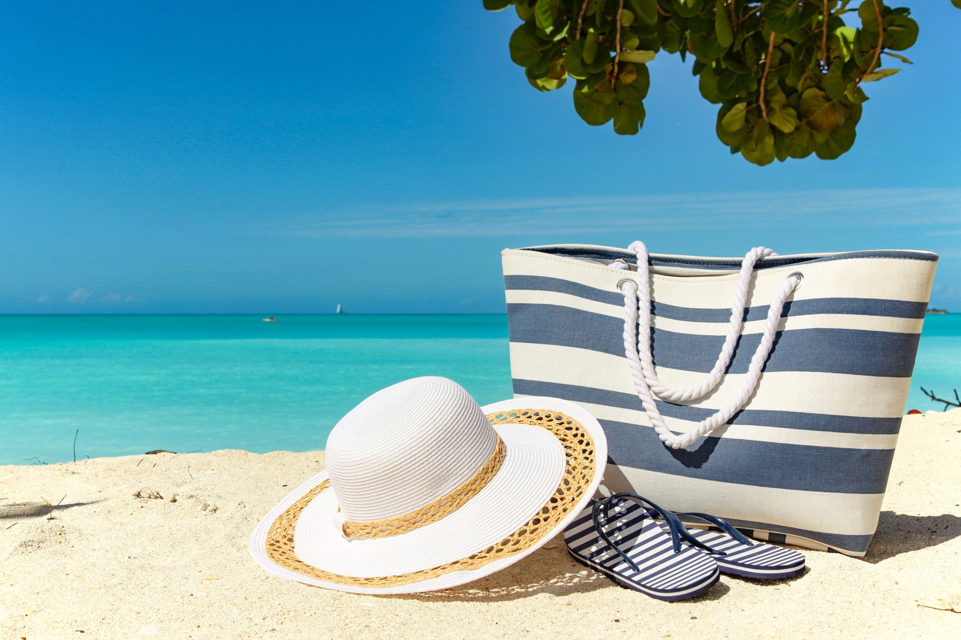 beach-bag-hat-and-flipflops-on-the-sand