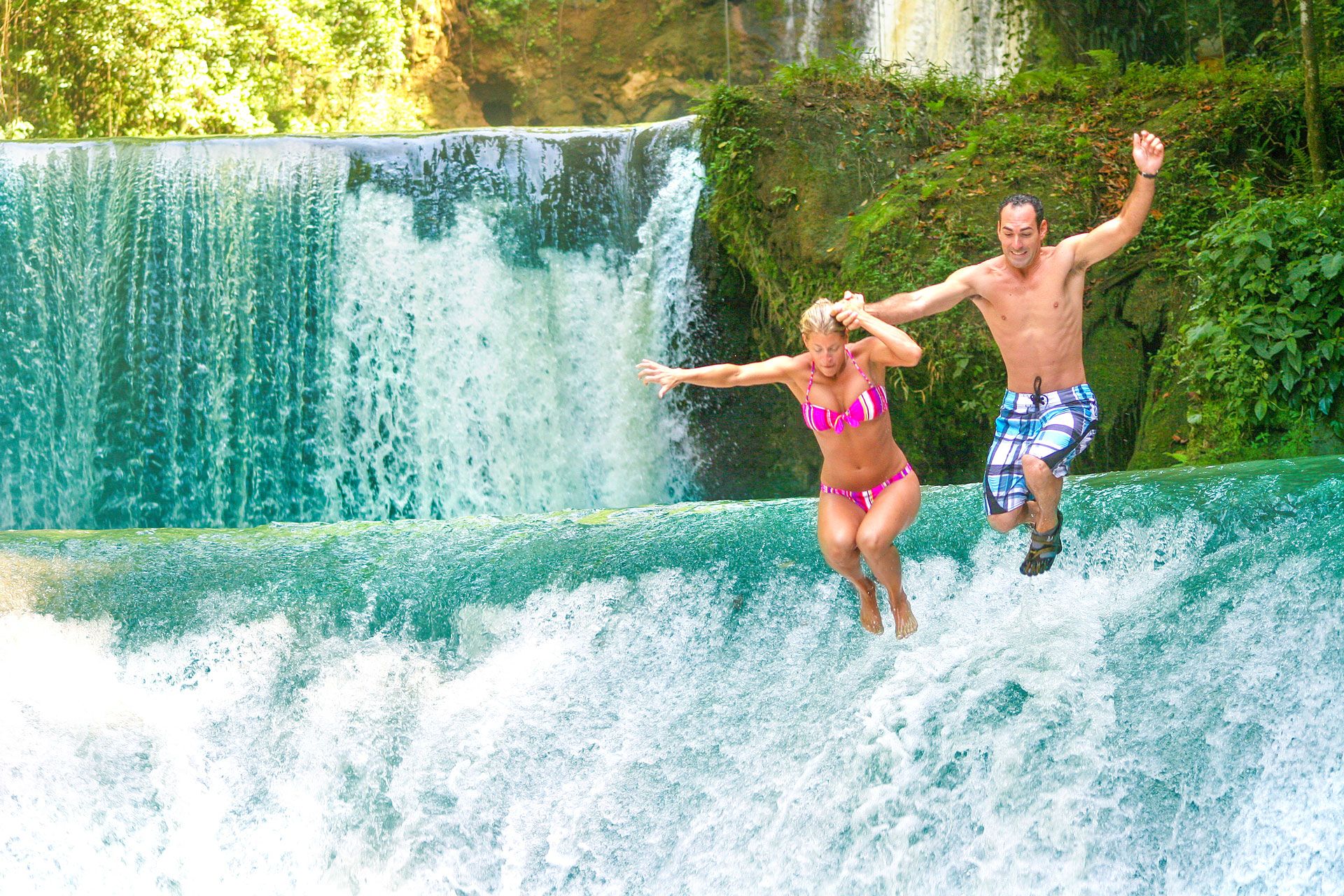 couple-jumping-from-waterfall-in-jamaica